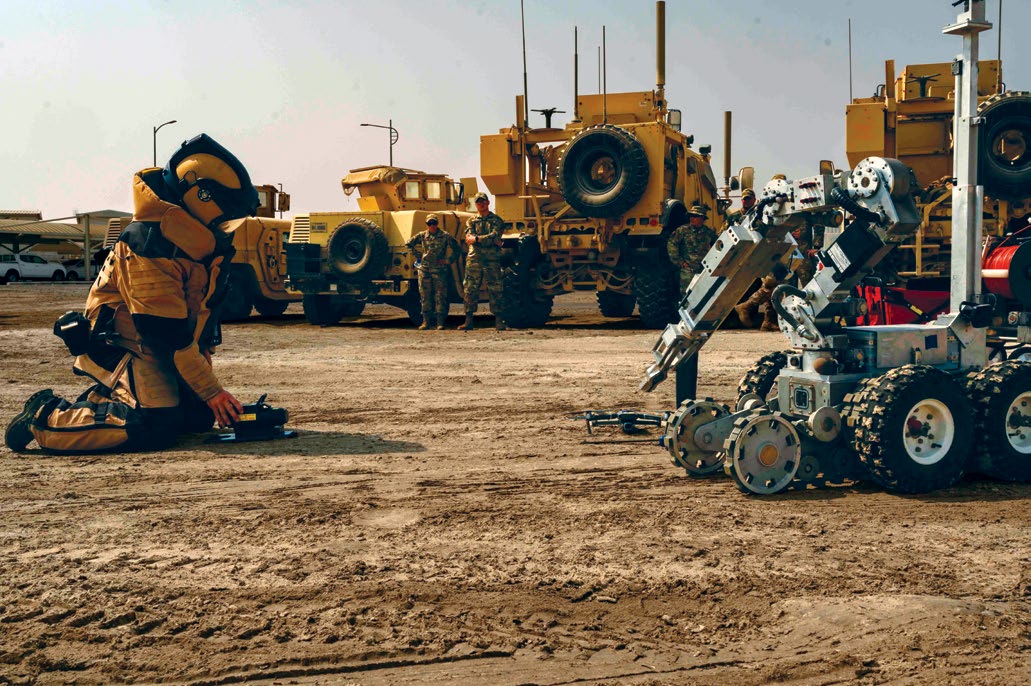 U.S. Air Force Tech. Sgt. Cameron Farrell, explosive ordnance team lead, assigned to the 380th Expeditionary Civil Engineer Squadron, approaches an ANDROS F6A robot during a training exercise at Al Dhafra Air Base, United Arab Emirates, August 6, 2021. The F6A is a highly dependable robot commonly used by the military for explosive ordnance disposal, reconnaissance, and other hazardous missions. (U.S. Air Force photo by Tech. Sgt. Michelle Y. Alvarez)